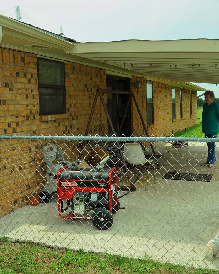 Portable generator on the patio of a brick home