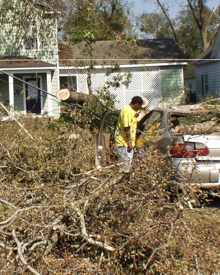 Fallen trees across a street and car in Plymouth, North Carolina, after Hurricane Isabel