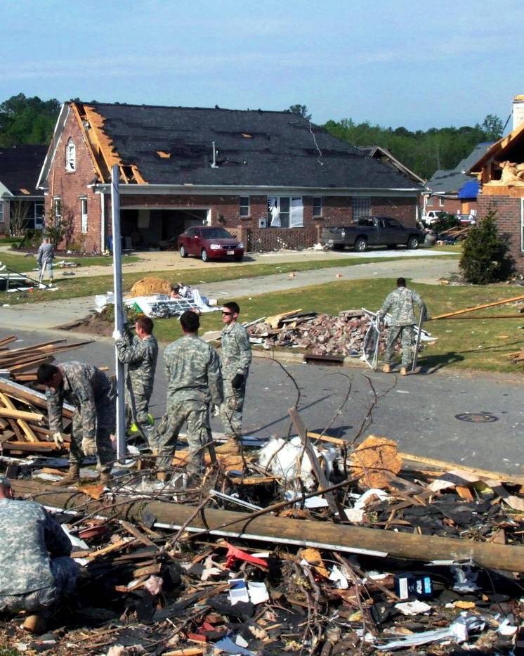Cleanup crews in a tornado-damaged neighborhood in Fayetteville, North Carolina