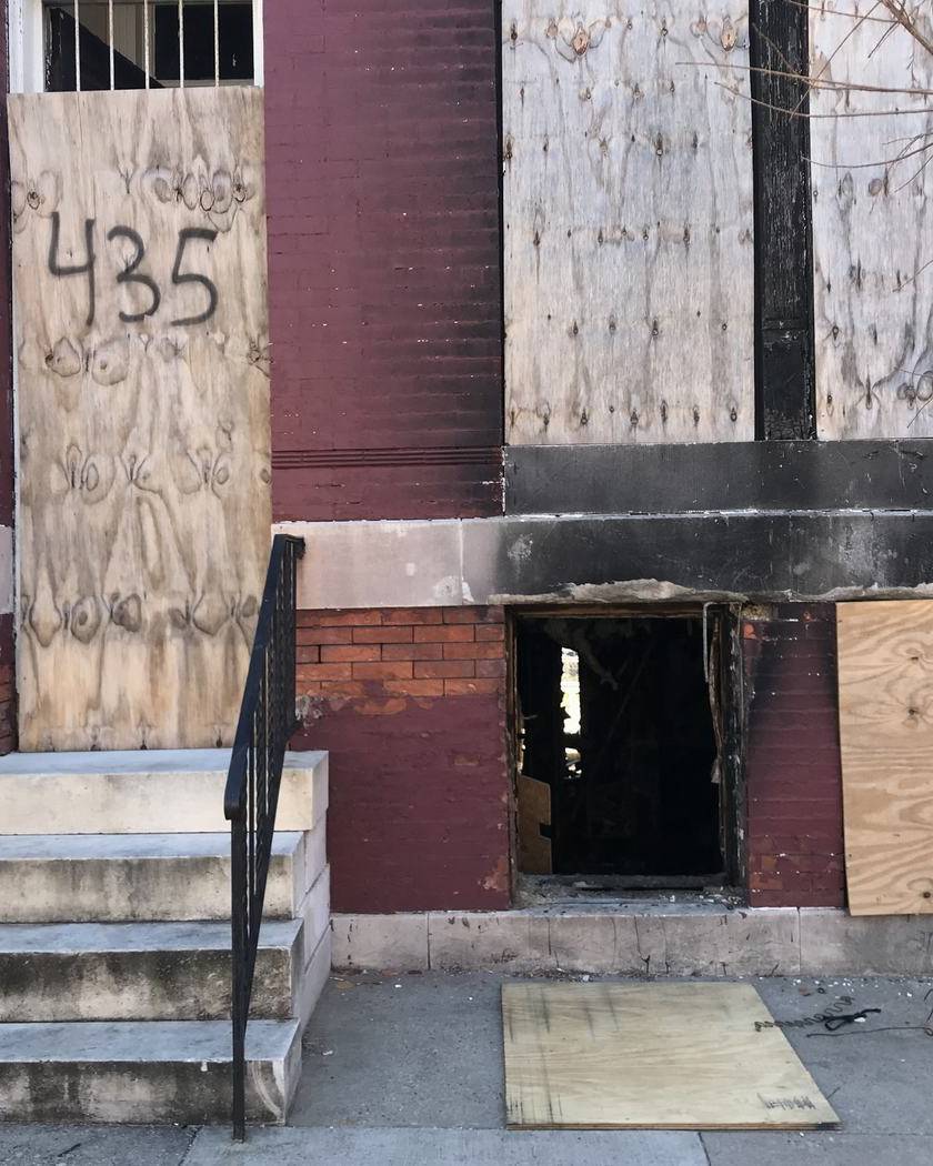 Smoke-stained doorway of a fire-damaged brick building